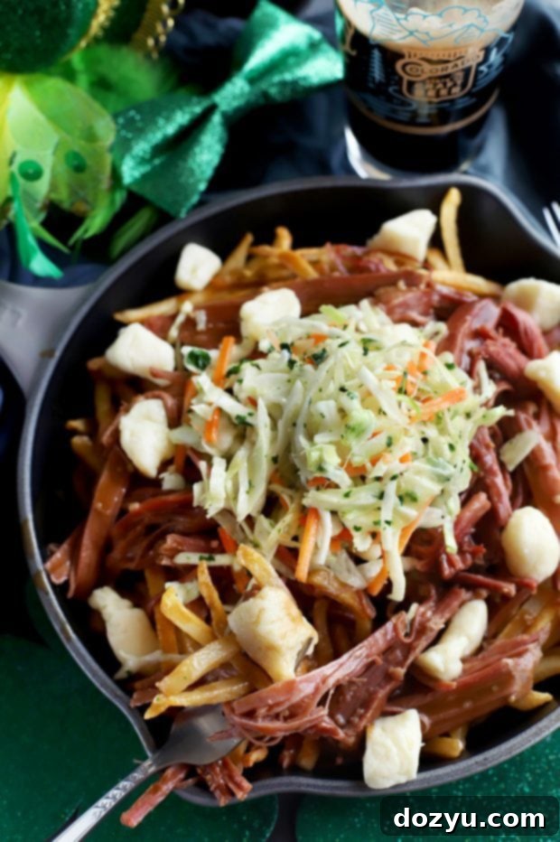 Hearty Corned Beef Poutine 8 A delicious Corned Beef Poutine served in a cast iron skillet, garnished with fresh parsley.