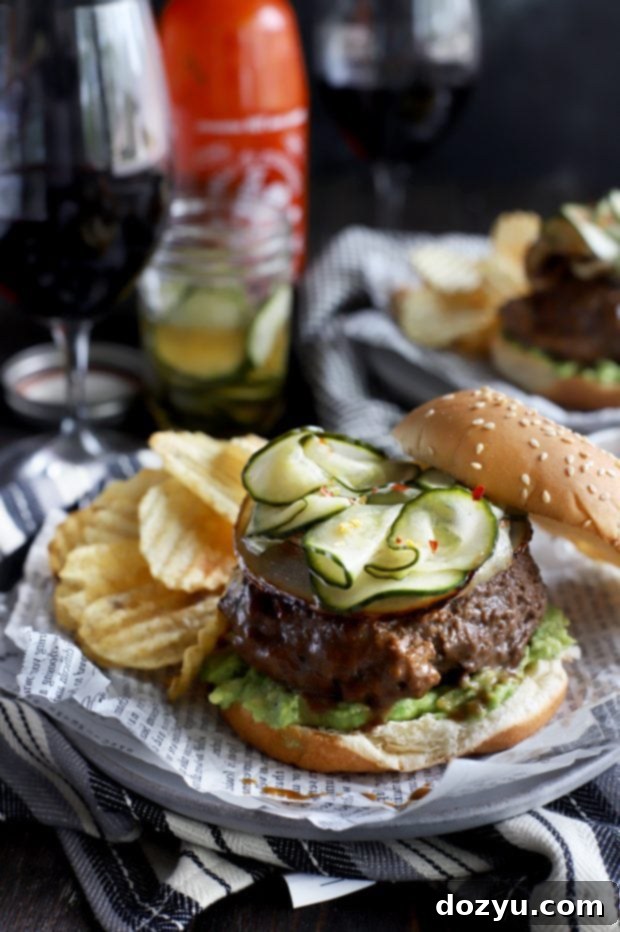 Spicy Miso Umami Burgers with Crisp Asian Pickles 2 A miso glazed sriracha burger topped with Asian cucumber pickles and avocado on a toasted bun.
