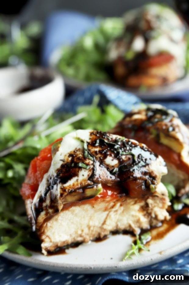 Caprese chicken breast cut in half, showing juicy inside