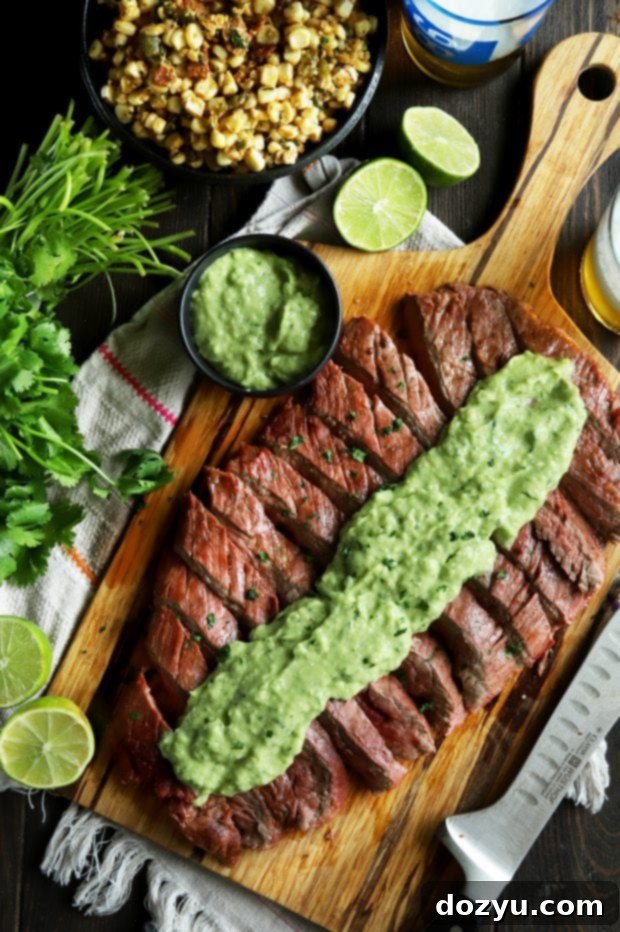 Sliced flank steak with creamy avocado salsa on top