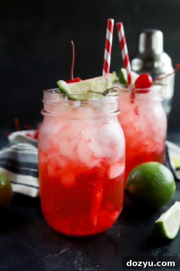 Scarlet Zest Elixir 2 mason jars of vodka cherry limeade with lime wedges