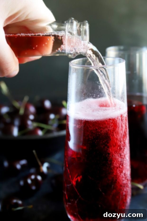Pouring sparkling rosé wine into a champagne flute, ready to mix into a mimosa