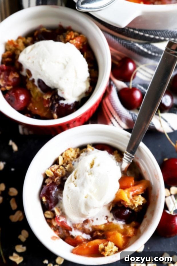 Sweet & Boozy Bourbon Cherry Peach Crumble 4 A small bowl of warm fruit crumble