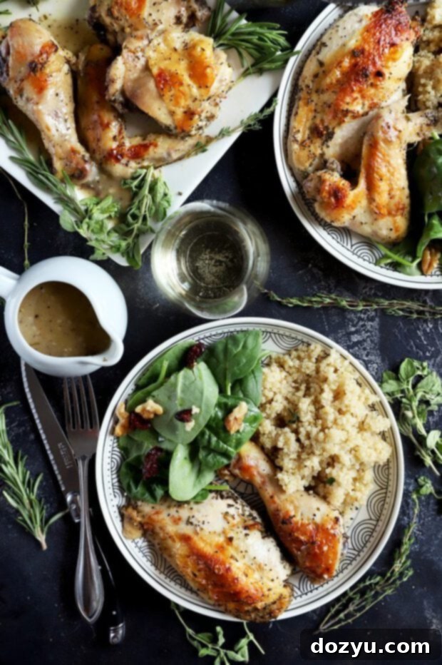 Aromatic White Wine and Herb Roasted Chicken 11 Chicken served on a plate with salad and quinoa