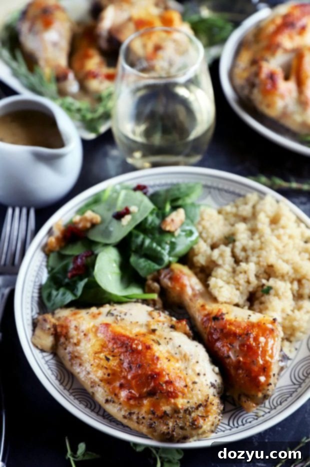 Aromatic White Wine and Herb Roasted Chicken 3 Side shot of chicken breast and leg on a plate