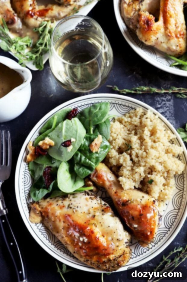 Aromatic White Wine and Herb Roasted Chicken 10 Roasted chicken on a plate with quinoa and salad