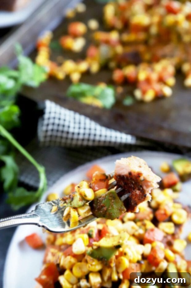 Pan-Seared Salmon with Charred Corn, Avocado and Tomato Salsa 5 Forkful of grilled salmon with vibrant corn avocado tomato salsa