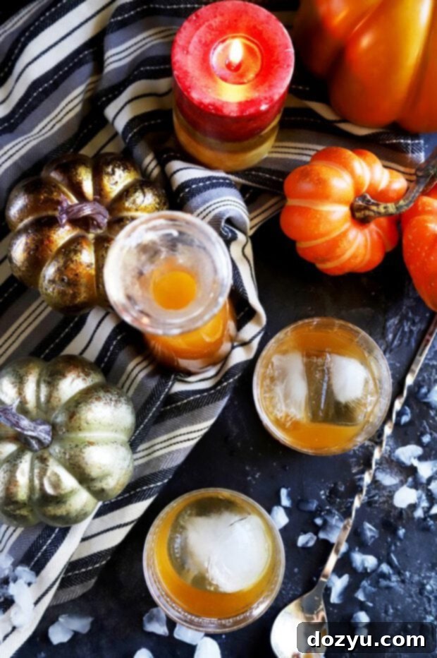 Autumn Ember Old Fashioned 3 Overhead view of a Pumpkin Spice Bourbon Old Fashioned cocktail garnished with orange peel and cinnamon