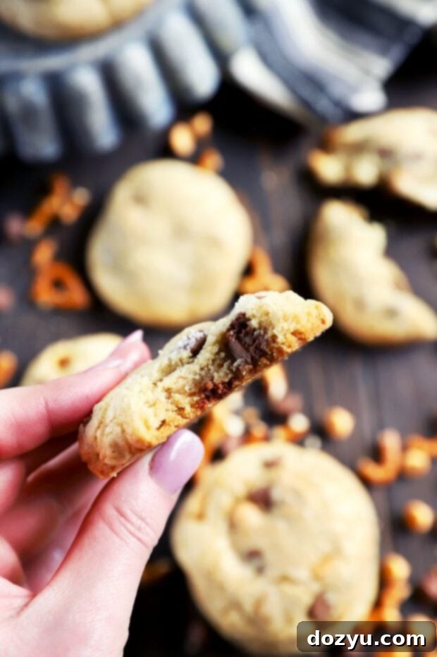 Crunchy Salty Sweet Caramel Butterscotch Cookies 5 Holding a chocolate chip cookie with a bite taken out of it