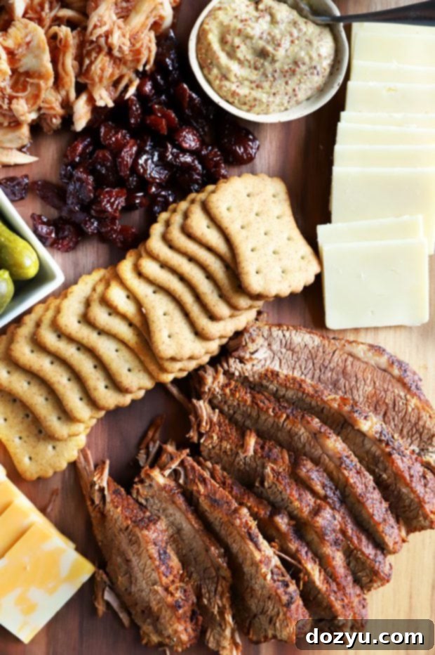 Assortment of crackers, cheese, and BBQ meat on a serving board