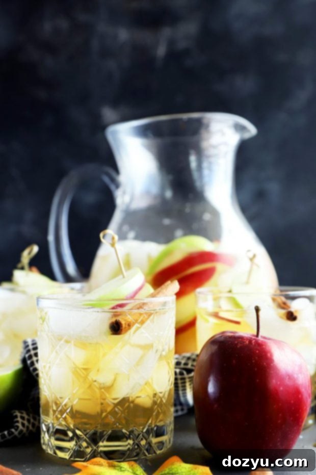 Effortless Apple Pie Sparkler 5 Elegant side view of apple pie sparkling sangria served in glasses, garnished with fresh apple slices