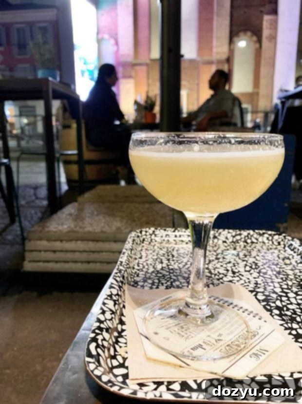 A close-up of a well-crafted cocktail at Mag Cafe in Milan, with a blurred background