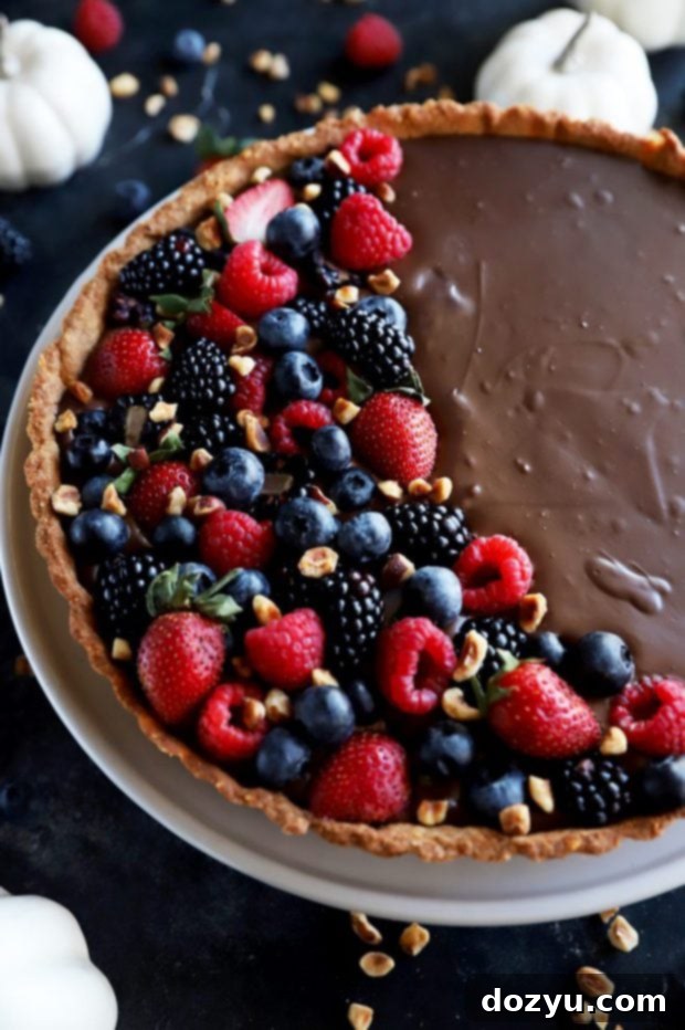 Side view of chocolate tart topped with berries