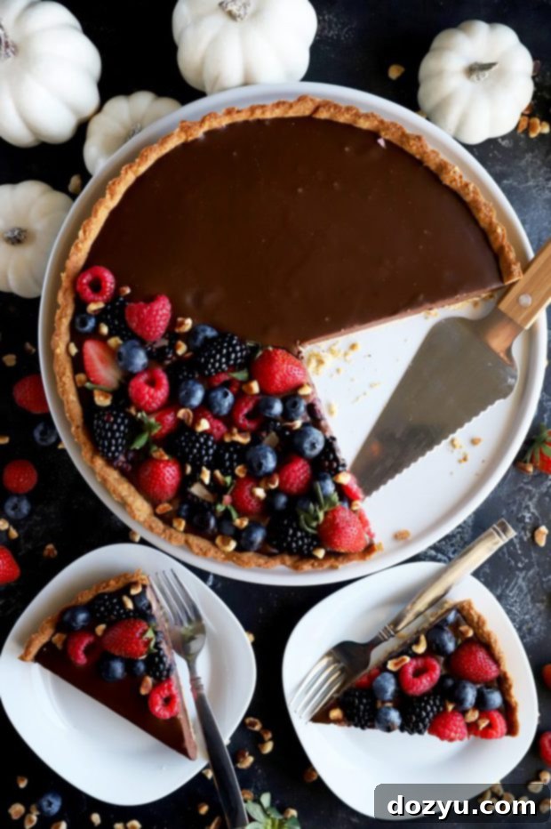 Slices of ganache tart topped with berries
