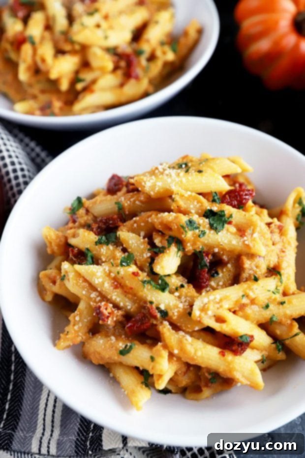 Garlic-Roasted Pumpkin Hummus Pasta 4 Bowl full of creamy pumpkin pasta with sun-dried tomatoes and cheese