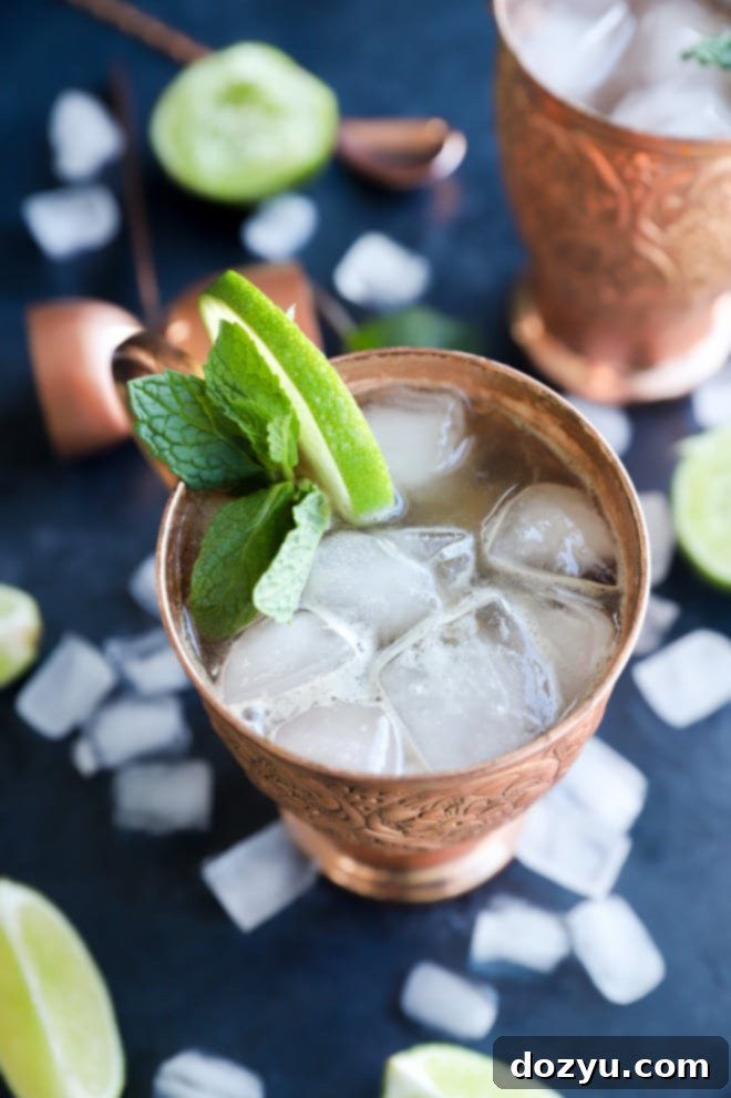 Kentucky Mule 3 A vibrant Kentucky Mule served in a chilled copper mug, garnished with fresh lime and mint