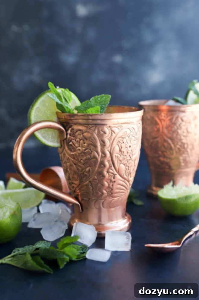 Kentucky Mule 4 Ingredients for a Kentucky Mule displayed alongside floral copper mugs