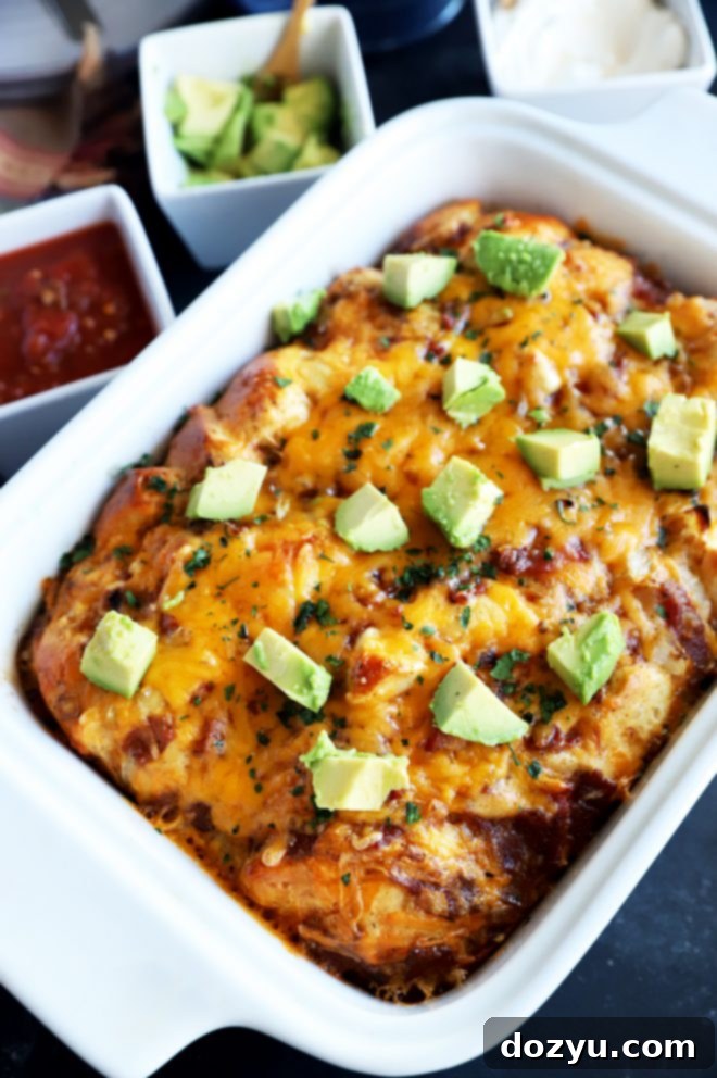 Close-up photo of the Mexican Biscuit Bake in a casserole dish, showing the golden-brown biscuits, eggs, bacon, and melted cheese, ready to be served.