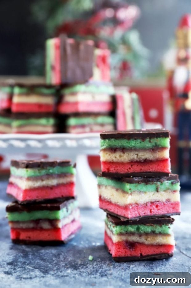 Rainbow Almond Delights 2 Italian Rainbow Cookies stacked up, showing their vibrant red, white, and green layers with chocolate