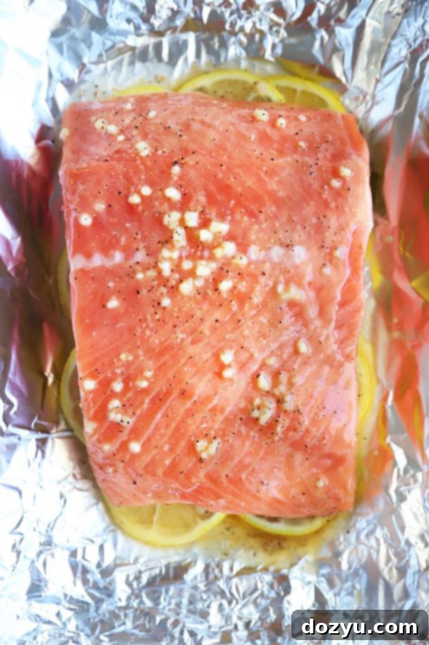 Zesty Lemon Garlic Salmon Bake 6 Salmon filet on lemon in foil photo