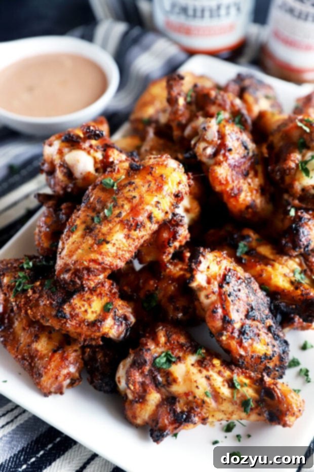 Smoky Dry-Rubbed Wings with Zesty BBQ Blue Cheese 3 Close-up of perfectly charred dry rub chicken wings on a grill