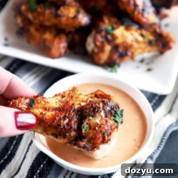 Smoky Dry-Rubbed Wings with Zesty BBQ Blue Cheese 9 Dipping a wing in BBQ blue cheese sauce