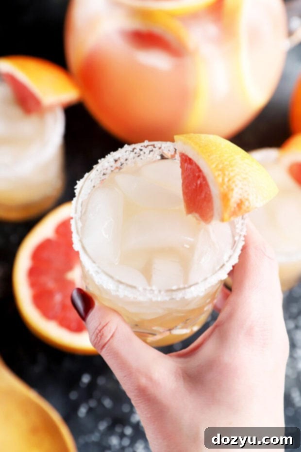 Hand holding a cocktail glass photo