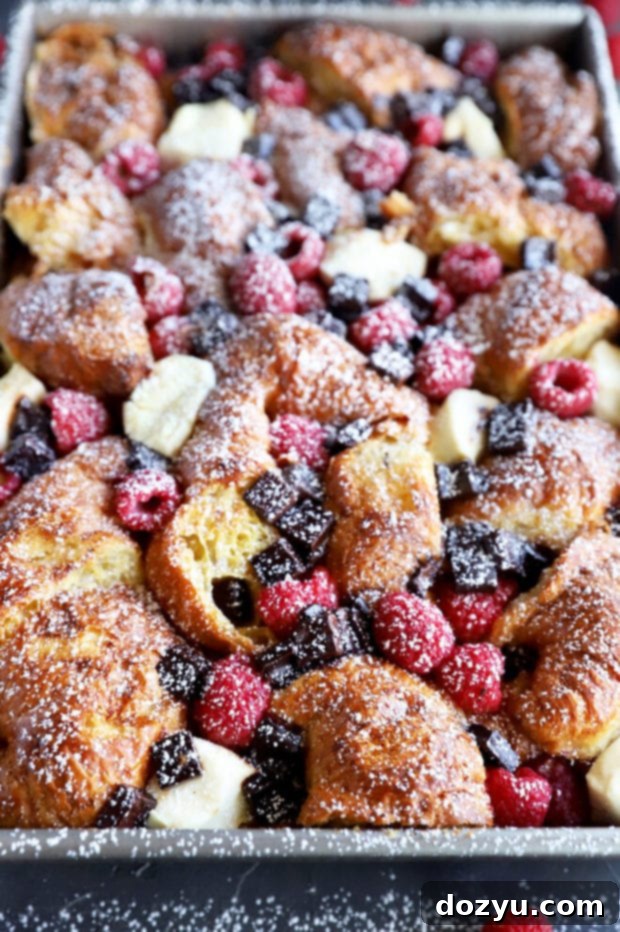 Decadent Raspberry Chocolate Croissant French Toast Casserole 8 Side photo of French toast bake in pan