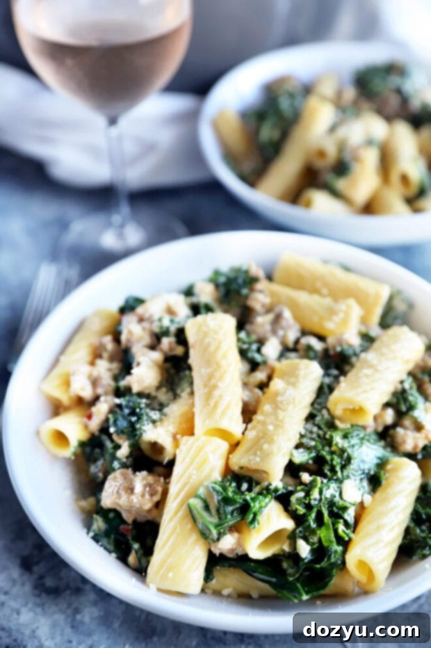 Rich Creamy Sausage Kale Rigatoni 5 A side view of a bowl of creamy sausage kale rigatoni pasta, showcasing the vibrant green kale and rich sauce.