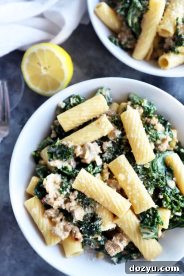 Rich Creamy Sausage Kale Rigatoni 9 Creamy sausage kale rigatoni pasta in a bowl, showing the creamy texture and pieces of sausage and kale.