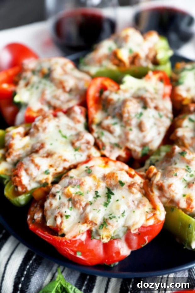 Bold Italian Stuffed Peppers 2 Plate of cheesy, spicy Italian stuffed peppers ready to eat, garnished with fresh basil.