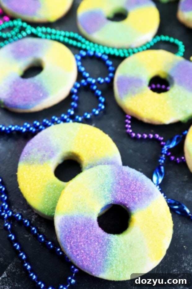 Beautifully decorated King Cake Cookies, capturing the festive spirit of Mardi Gras with purple, green, and gold sprinkles.