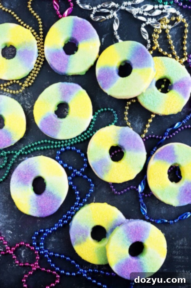 Overhead photo of King Cake Cookies arranged artfully, showcasing their colorful sprinkles and perfect round shape.