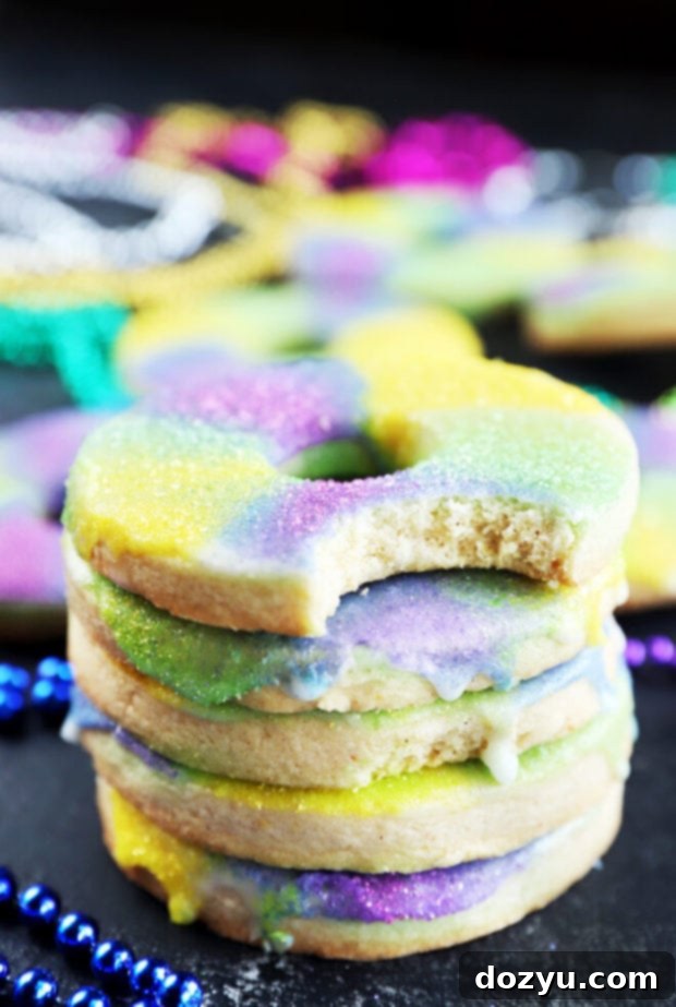 A stack of beautifully glazed and decorated King Cake Cookies, showcasing the Mardi Gras colors.