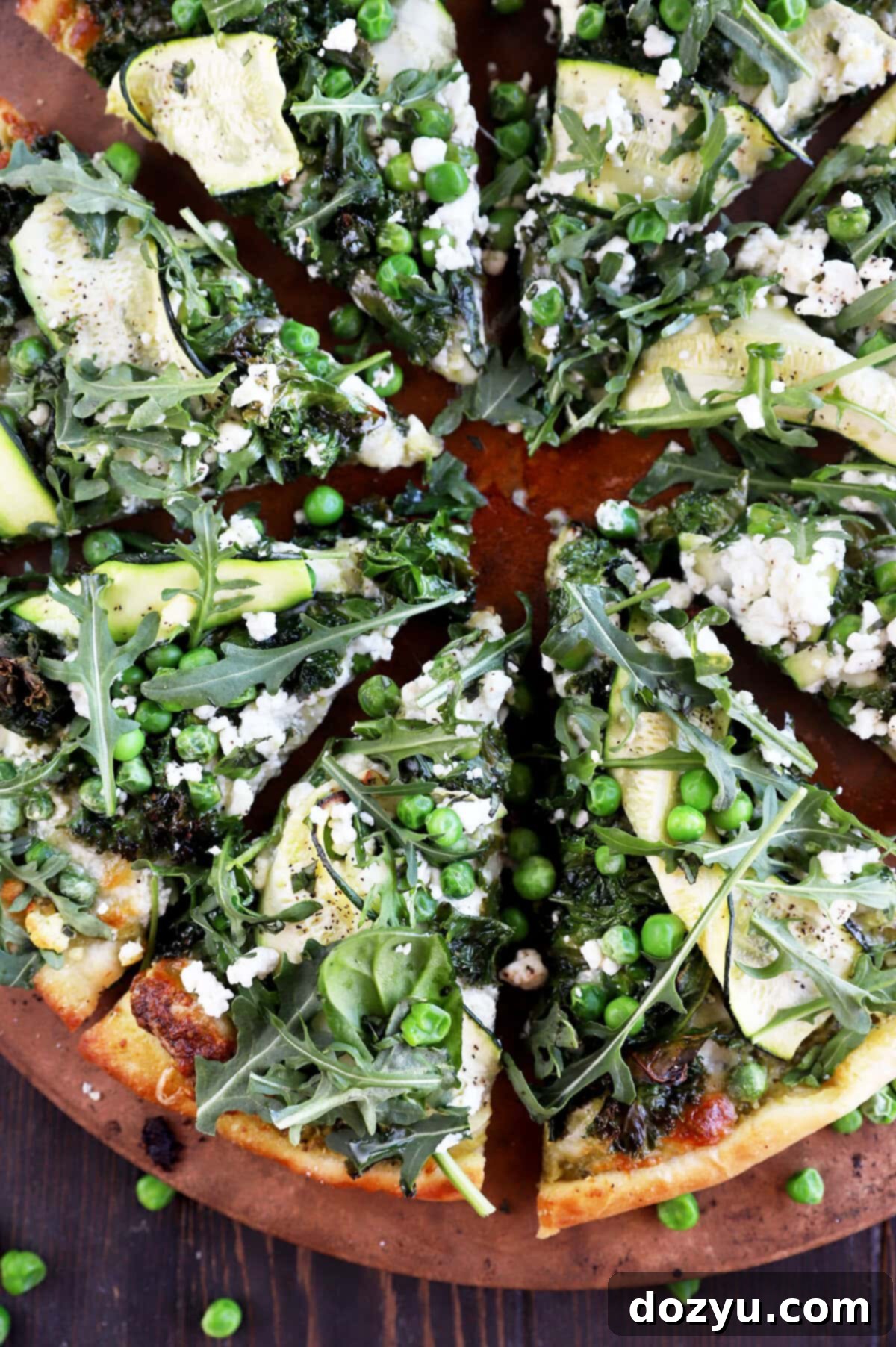 Garden Pesto Pizza 11 Delicious Pesto Green Pizza topped with fresh kale, zucchini, arugula, and peas.