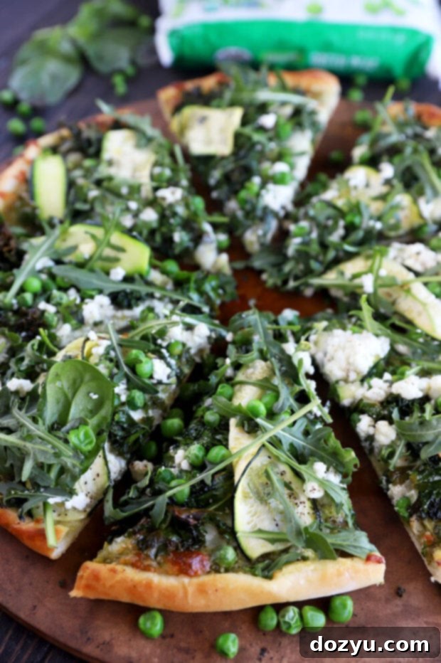 Garden Pesto Pizza 3 Greens pizza on a pizza stone photo