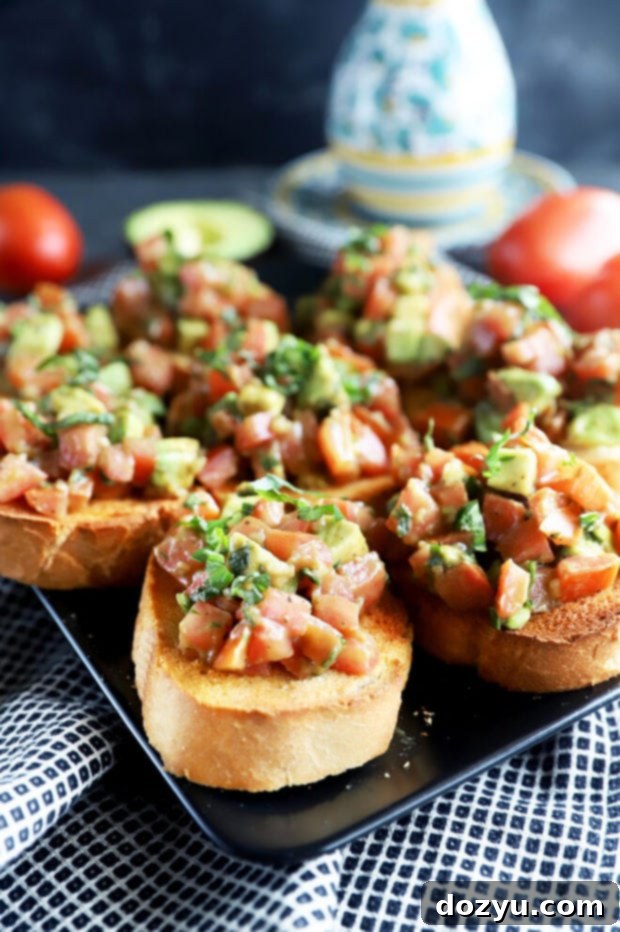 Side picture of bruschetta on toast, showing the fresh ingredients clearly