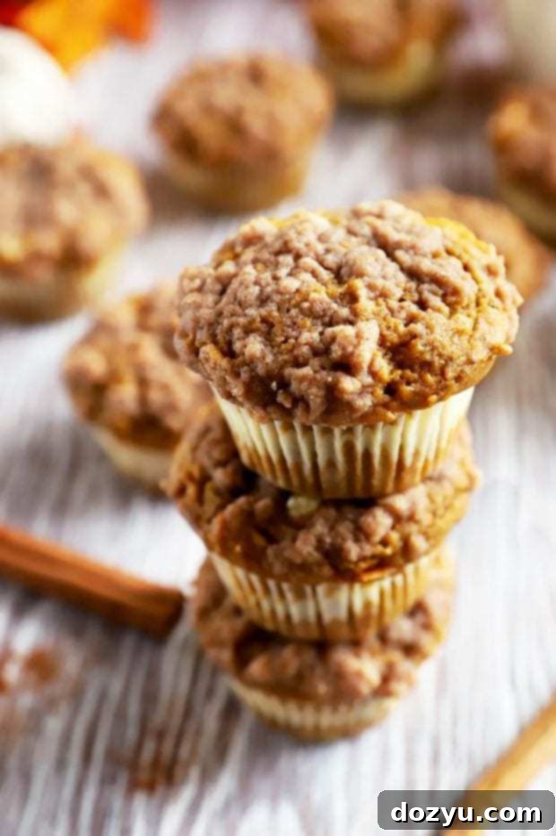 Cream Cheese Swirl Pumpkin Crumble Muffins 7 A beautiful stack of five pumpkin cream cheese muffins, perfect for a fall breakfast or dessert