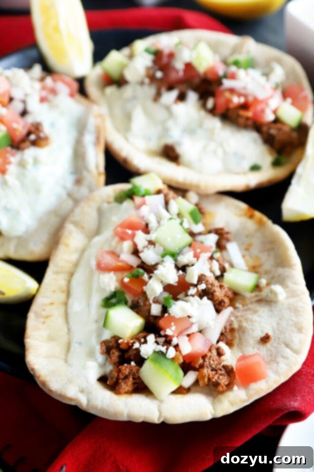 Savory Greek Beef Wraps 4 Close-up picture of ground beef in Greek pitas, ready to eat