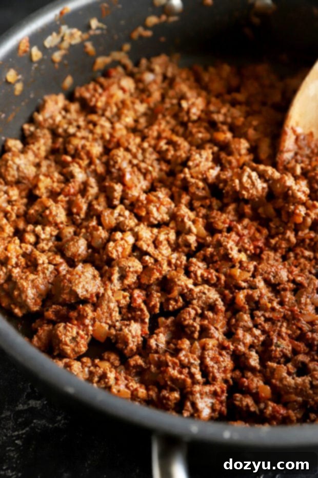 Savory Greek Beef Wraps 7 Ground beef cooking in a pan with onions and garlic