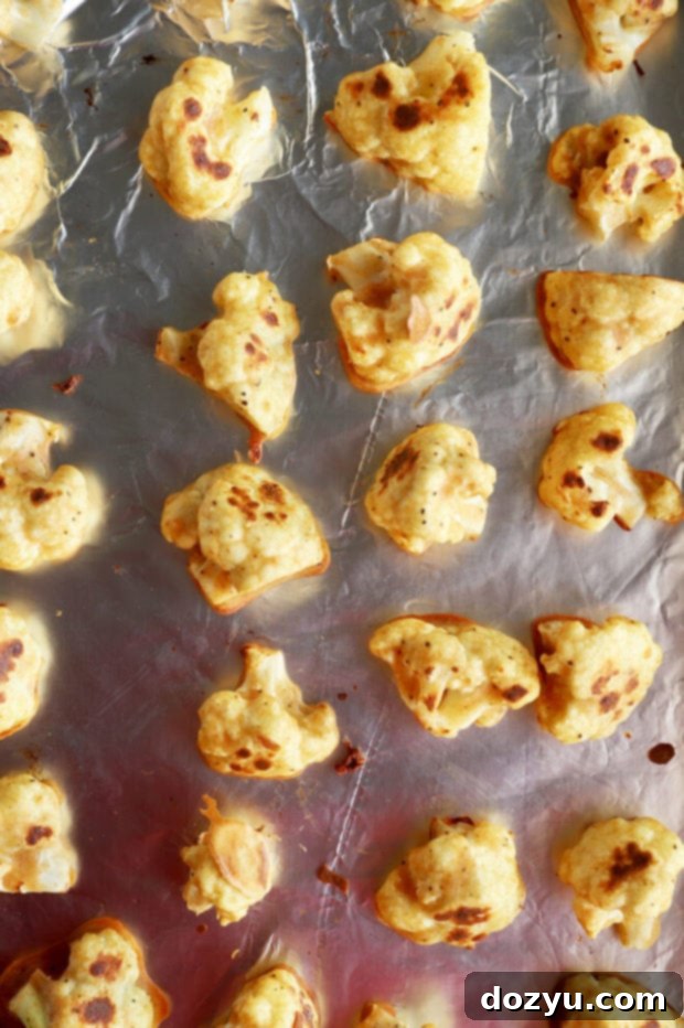 Golden Crispy Buffalo Cauliflower Wings 4 Baked cauliflower on foil-lined pan picture