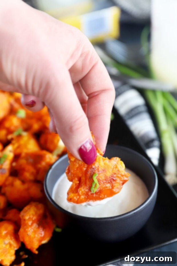 Golden Crispy Buffalo Cauliflower Wings 6 Dipping cauliflower in ranch picture