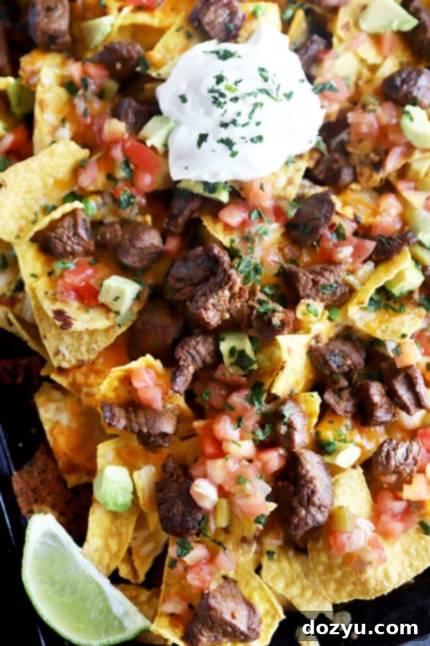 Ultimate Carne Asada Nachos 3 Carne asada nachos on a pan picture