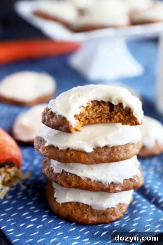 Spiced Carrot Cake Cookies 5 Bite taken out of a carrot cake cookie, showing the soft interior