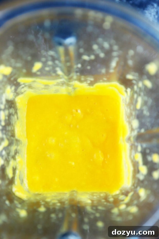 Refreshing Mango Mojito Mocktail 7 Smooth, vibrant mango puree in a blender, ready for the mocktail.