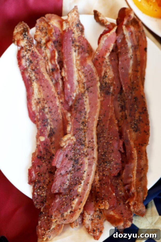 Craft Your Ultimate Gourmet BBQ Burger Bar 11 Close-up of crispy black pepper bacon strips, a gourmet burger topping.
