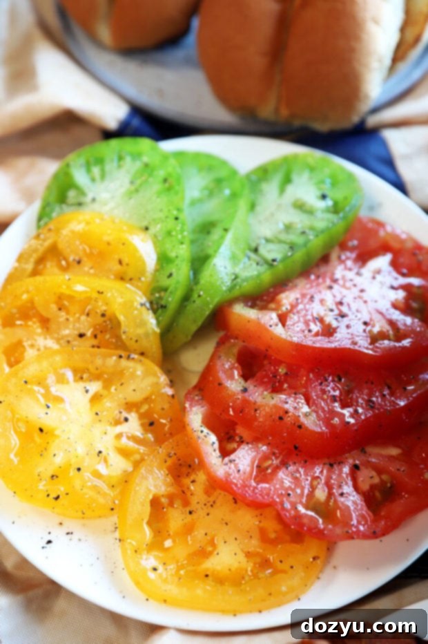 Craft Your Ultimate Gourmet BBQ Burger Bar 3 Sliced heirloom tomatoes, vibrant and fresh, ready for gourmet burgers.
