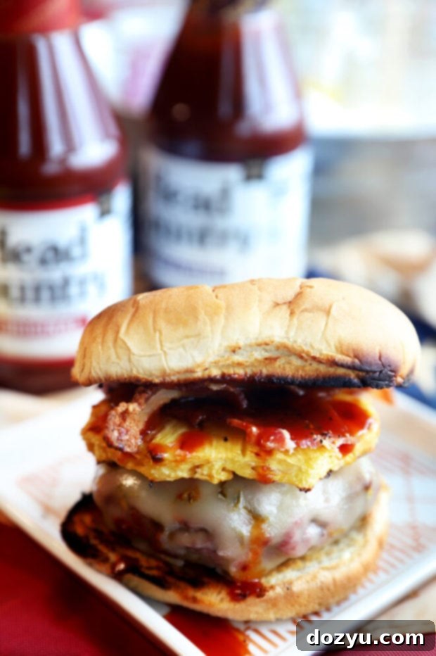 Craft Your Ultimate Gourmet BBQ Burger Bar 7 A vibrant Hawaiian BBQ Burger with grilled pineapple, pepper jack cheese, and bacon.