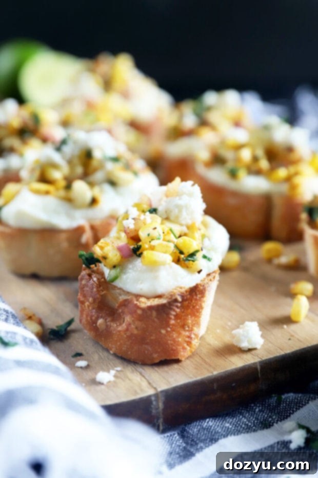 Zesty Grilled Elote Crostini 3 Side view of a serving of grilled mexican corn crostini, showing the creamy ricotta and corn topping