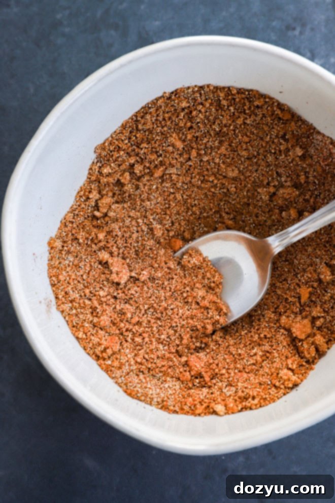 Fall-Off-The-Bone Apple Cider Traeger Ribs 4 spice mix in a bowl with a spoon